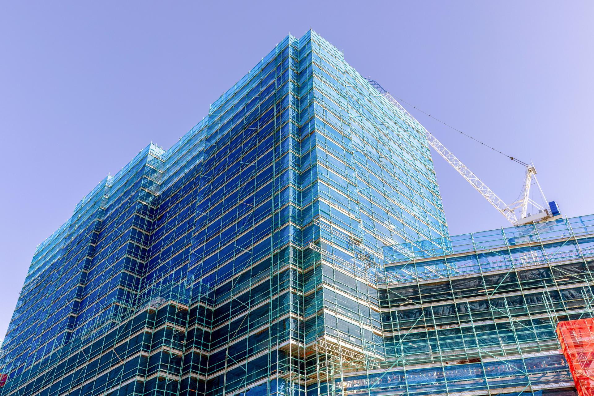 Construction of modern apartment building, background with copy space